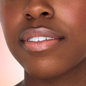 Indie Lee Nourishing Lip Tint in shade Embrace, a subtle nude shade.