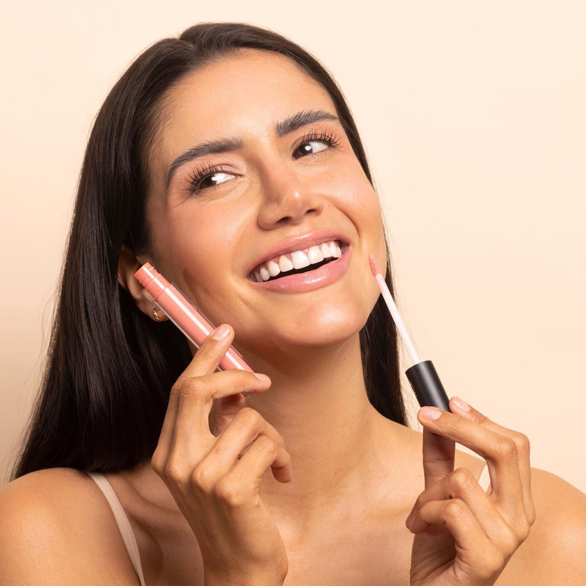 TOK Beauty Lip Tonic in shade Bloom, a moisturizing, non-sticky lip gloss with a peachy coral hue.