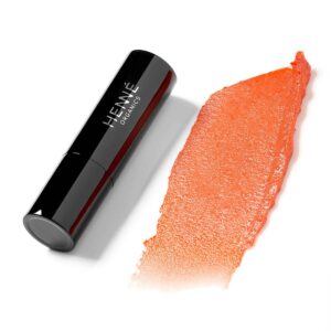 Henne Coral Tinted Lip Balm, a buildable soft coral hue.