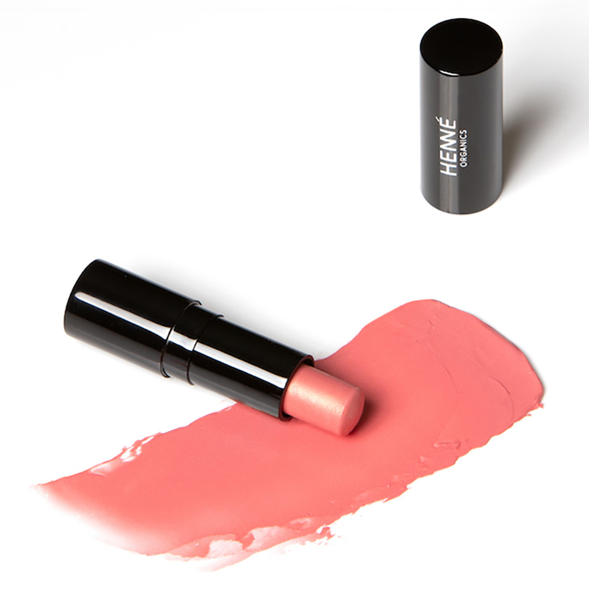 Henne Sunlit Tinted Lip Balm, a buildable summery peachy hue.