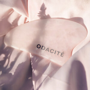 Odacité Rose Quartz Crystal Contour Gua Sha Beauty Tool available at Inspire Beauty.