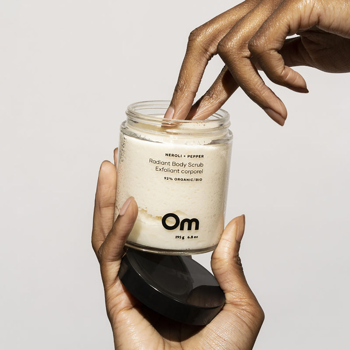 Om Organics Neroli + Pepper Radiant Body Scrub exfoliates as it softens and moisturizes skin.